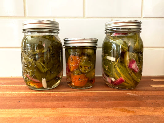 jars of pickled jalapeno with onion and garlic
