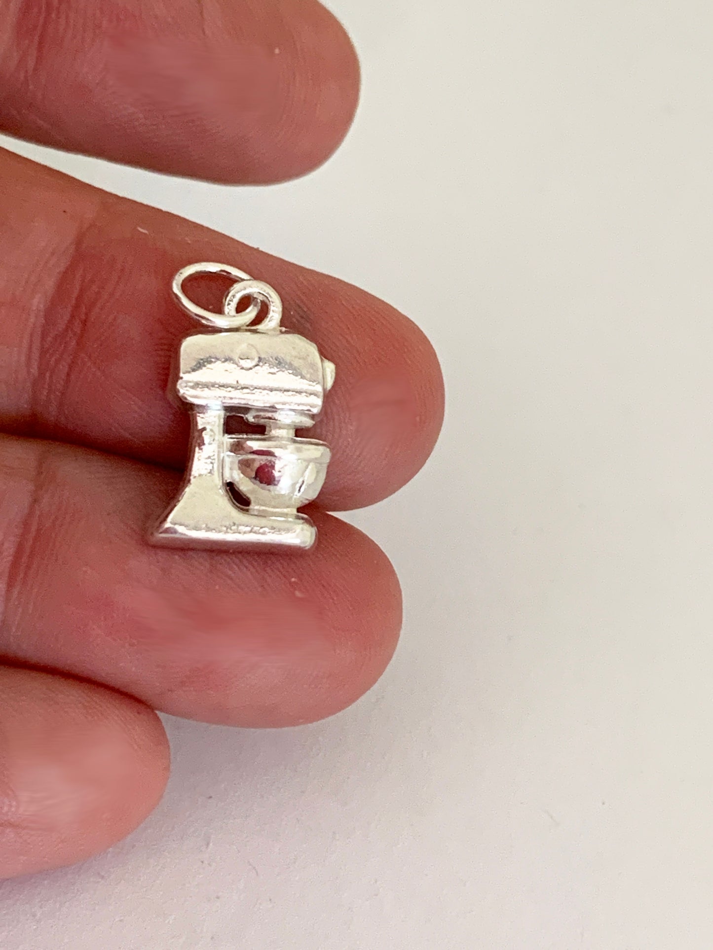 sterling standing mixer charm in hand